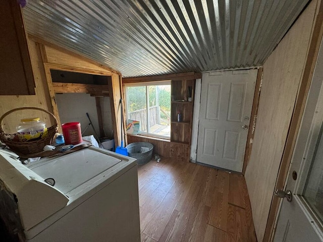 washroom with wooden walls and hardwood / wood-style flooring