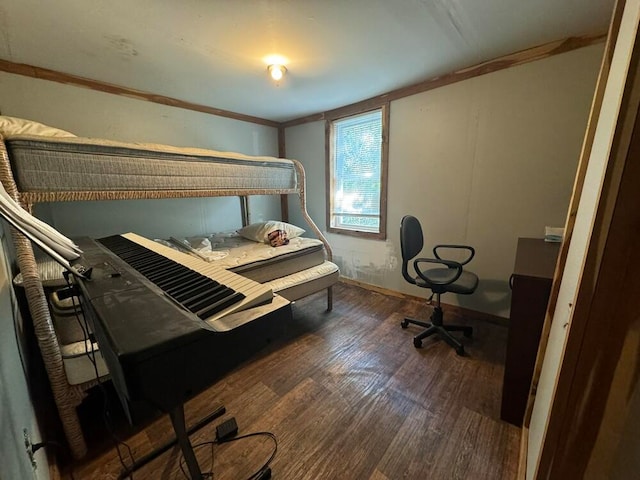 bedroom with crown molding and dark hardwood / wood-style flooring