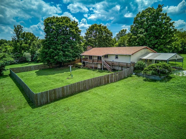 view of yard with a deck, stairway, and a fenced backyard