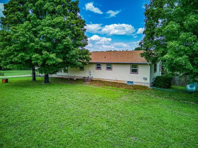 back of property with a lawn