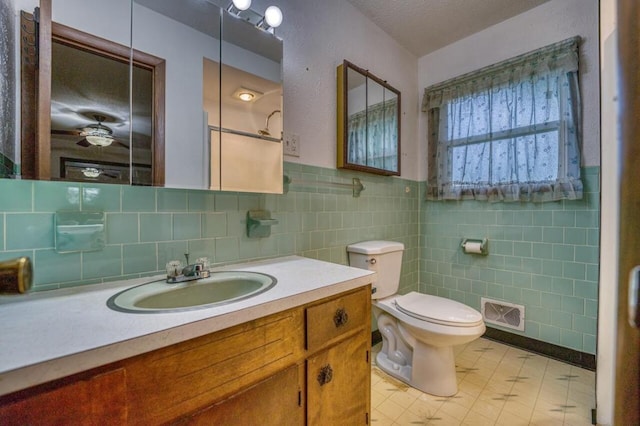 bathroom with visible vents, toilet, and vanity