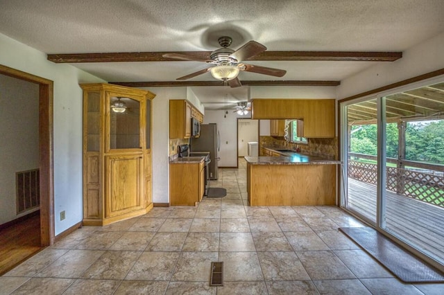 kitchen with visible vents, brown cabinets, beamed ceiling, and decorative backsplash