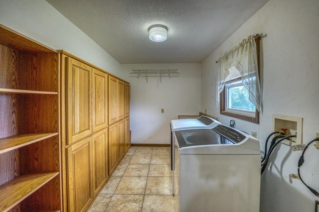 laundry area with baseboards, cabinet space, a textured ceiling, and independent washer and dryer