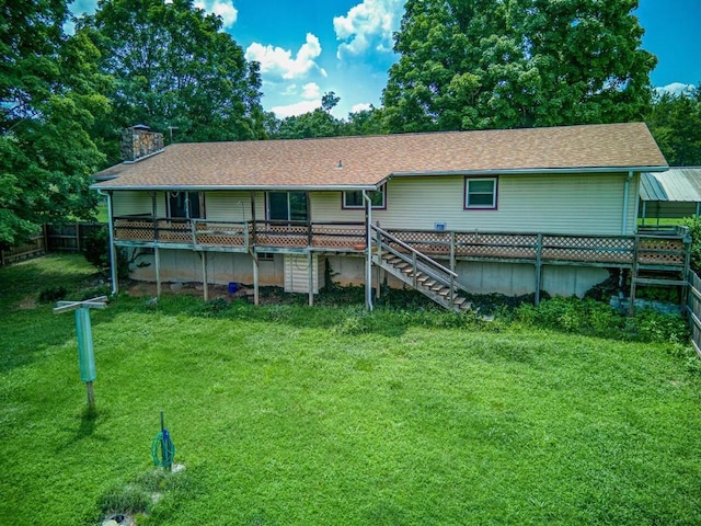 back of property featuring a lawn, a chimney, fence, roof with shingles, and stairs