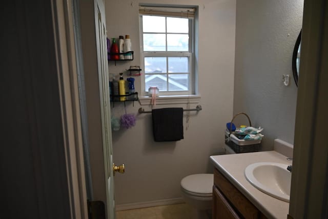 bathroom with tile patterned flooring, toilet, and vanity