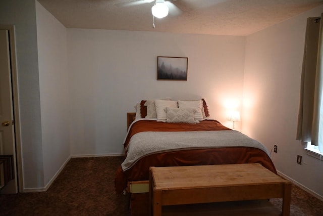 carpeted bedroom with ceiling fan and a textured ceiling