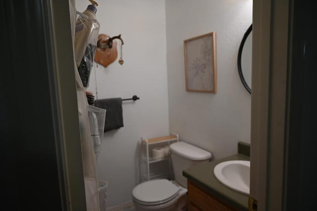 bathroom with toilet and vanity