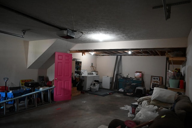 garage featuring washer and dryer and a garage door opener