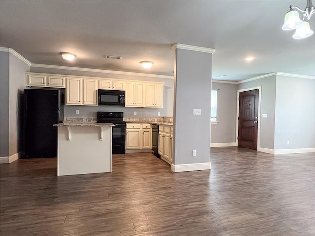 kitchen featuring baseboards, visible vents, dark wood-type flooring, a center island, and black appliances