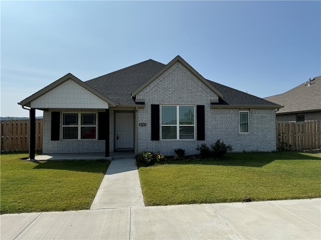 single story home featuring a front yard