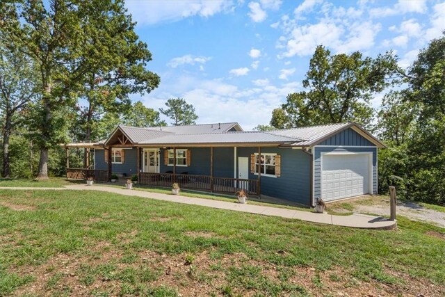 ranch-style house featuring a garage, a porch, and a front yard