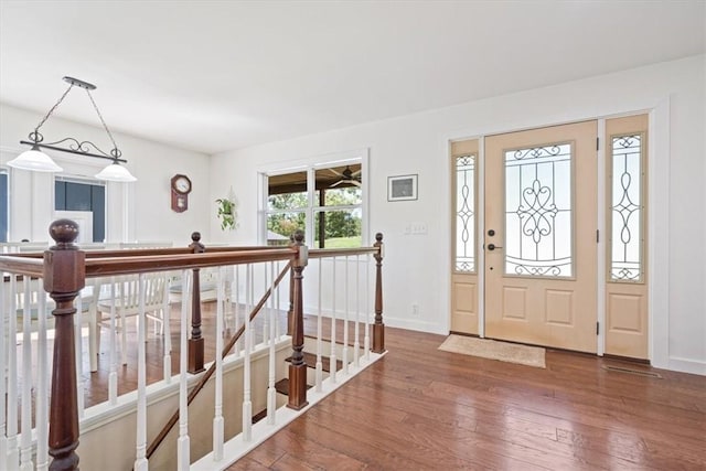 entryway featuring hardwood / wood-style floors and baseboards