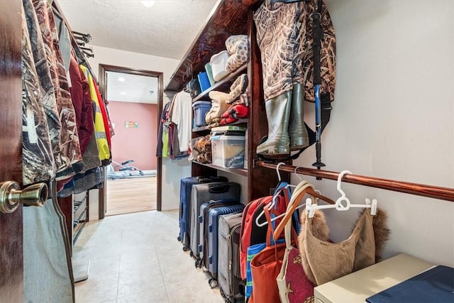 spacious closet with tile patterned floors