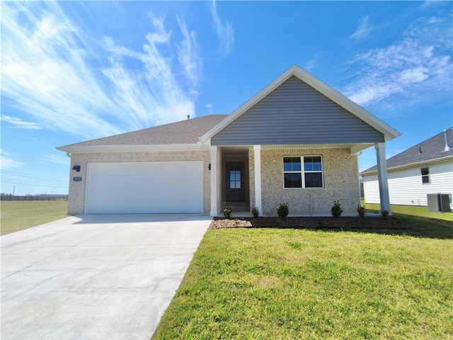 view of front facade with a garage, central AC, and a front yard