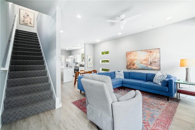 living room featuring light wood-style floors, stairway, a ceiling fan, and recessed lighting