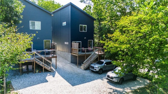 back of house featuring a deck and stairs