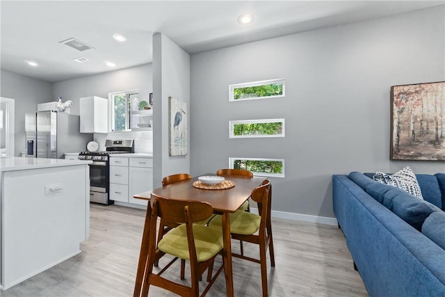 dining area with light wood-style flooring, recessed lighting, visible vents, and baseboards