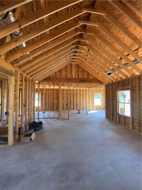 misc room featuring concrete floors and vaulted ceiling