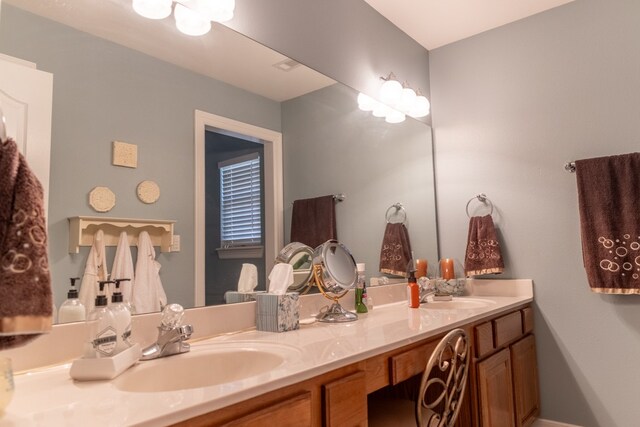 bathroom featuring dual vanity