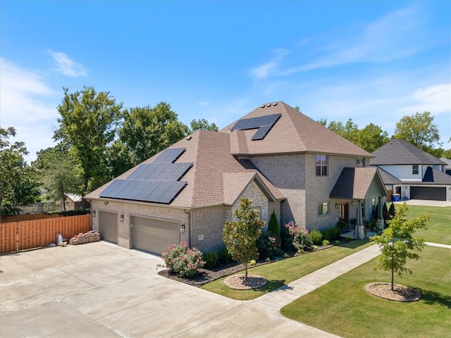 view of home's exterior with a lawn, solar panels, and a garage