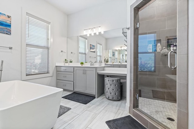 bathroom featuring separate shower and tub, tile patterned floors, vanity, and a healthy amount of sunlight