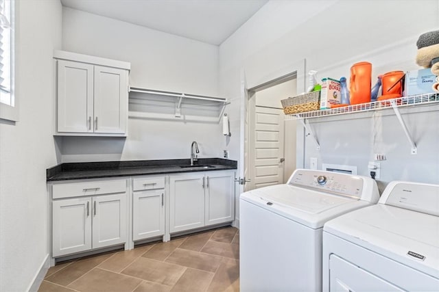 laundry area with light tile patterned floors, sink, independent washer and dryer, and cabinets