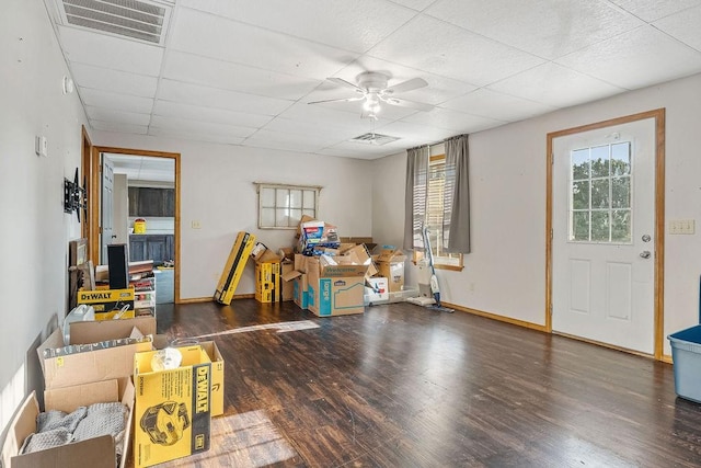 miscellaneous room with dark hardwood / wood-style flooring, ceiling fan, and a drop ceiling