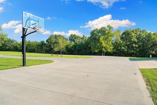 view of basketball court with a lawn