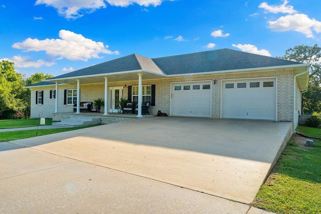 view of front of home with a porch and a garage