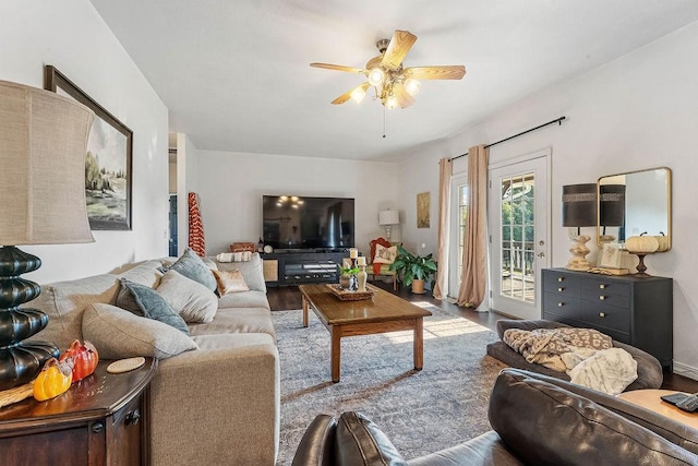 living room featuring wood-type flooring and ceiling fan