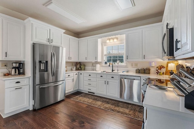 kitchen featuring sink, stainless steel appliances, dark hardwood / wood-style floors, and white cabinets