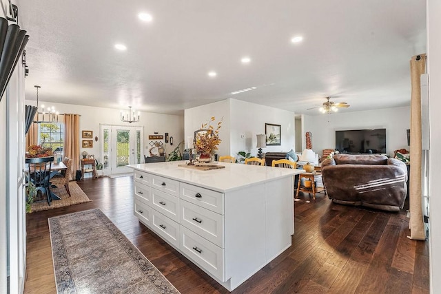 kitchen featuring pendant lighting, white cabinetry, a center island, and dark wood-type flooring