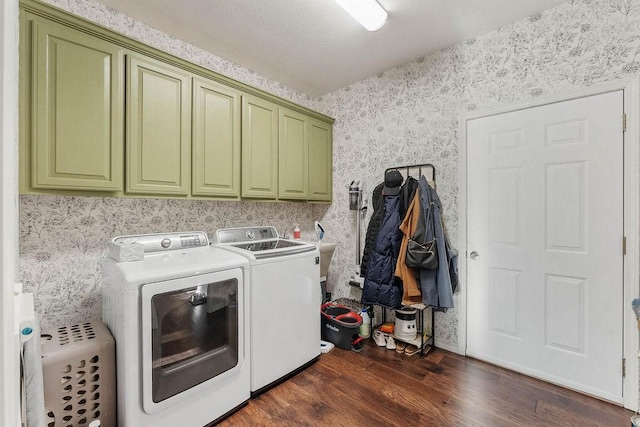 laundry room with separate washer and dryer, dark hardwood / wood-style flooring, and cabinets