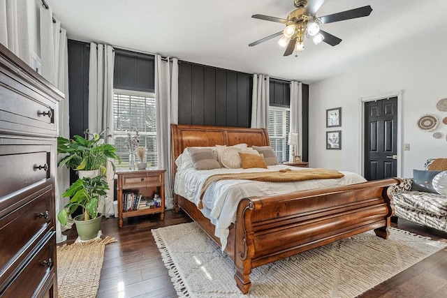 bedroom with ceiling fan and dark hardwood / wood-style flooring