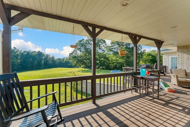 wooden terrace with a lawn