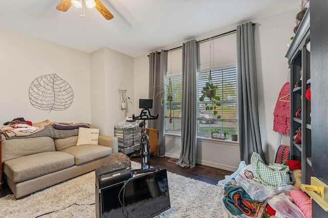 living room featuring dark hardwood / wood-style floors and ceiling fan