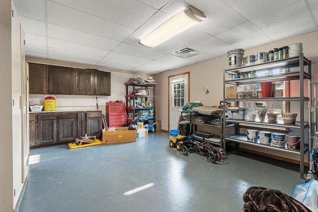 interior space with a paneled ceiling