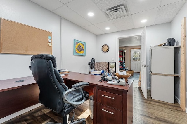 office space featuring a drop ceiling and hardwood / wood-style floors