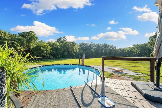 view of pool with a lawn