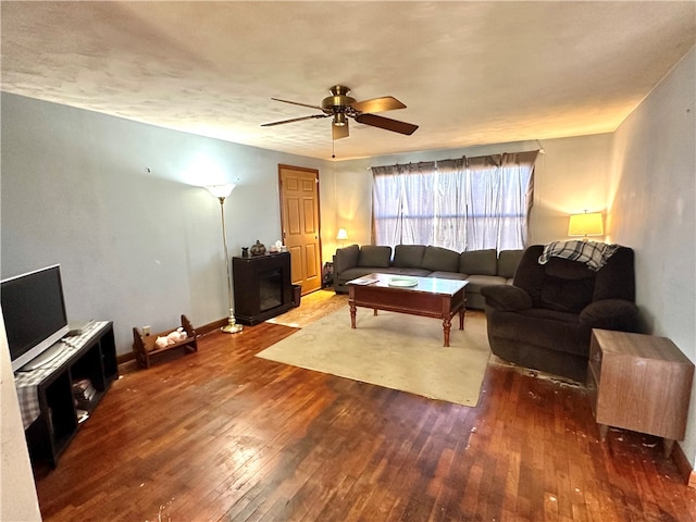 living room featuring ceiling fan and hardwood / wood-style floors