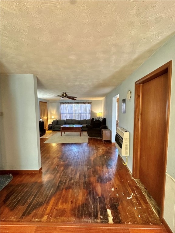 unfurnished living room featuring a textured ceiling, ceiling fan, and hardwood / wood-style flooring