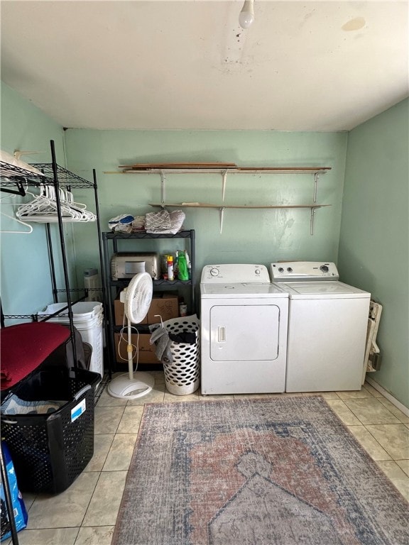 laundry room featuring independent washer and dryer and light tile patterned floors