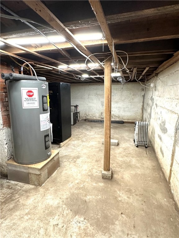 basement with electric water heater and radiator