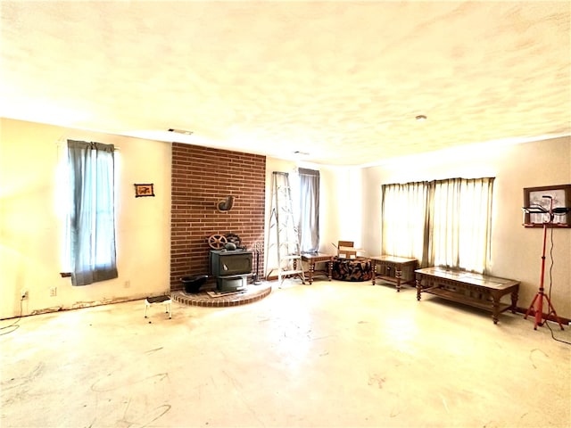 misc room featuring brick wall and a wood stove