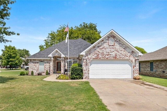 view of front of home featuring a garage and a front lawn