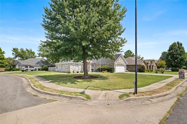 view of front of property with a garage and a front yard