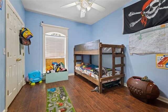 bedroom with hardwood / wood-style flooring, ceiling fan, and baseboards