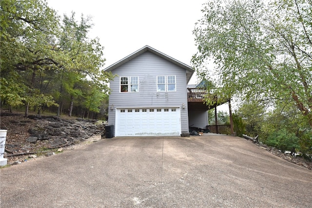 view of side of home with a deck and a garage