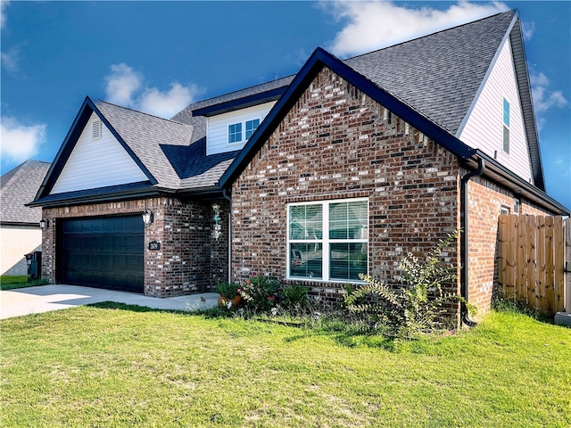 view of front of home featuring a front yard and a garage