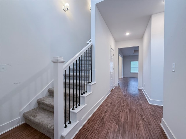 staircase with wood-type flooring